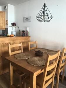 a wooden table with chairs and a dining room at Chalets Du Galibier I - 2 Pièces pour 4 Personnes 74 in Valloire
