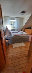 a large bed in a room with a window at Ferienwohnung an der Lahn in Limburg an der Lahn
