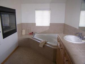 a bathroom with a tub and a sink at Hideaway Down Canyon #101 in June Lake
