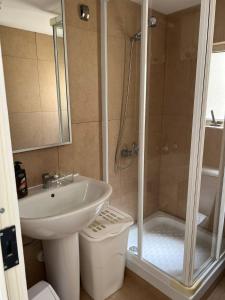 y baño con lavabo y ducha. en Mellieha Bay Seafront With Spectacular Views3bed, en Mellieħa