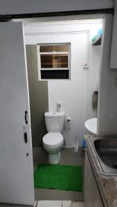 a small bathroom with a toilet and a sink at Cosy Corner #2 in Bridgetown