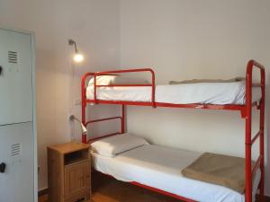 a room with two bunk beds and a night stand at New Hostel Florence in Florence