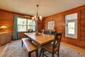 a dining room with a wooden table and chairs at Bright Home with Outdoor Space, Steps to River in Indian River