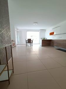 a large white room with a kitchen and a table at Cosy 2bed Apartment In Manikata By Homely in Mellieħa