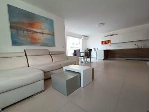 a living room with a couch and a table at Cosy 2bed Apartment In Manikata By Homely in Mellieħa