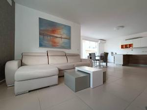 a living room with a couch and a table at Cosy 2bed Apartment In Manikata By Homely in Mellieħa