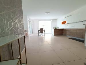 a large kitchen with a large white tile floor at Cosy 2bed Apartment In Manikata By Homely in Mellieħa