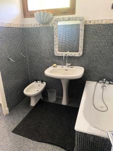 a bathroom with a sink and a toilet and a mirror at Résidence Lavoir - Maisons & Villas 424 in Villard-de-Lans