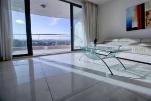 A seating area at The Strand Apartments By Homely