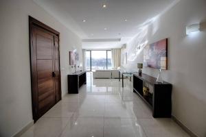 A television and/or entertainment centre at The Strand Apartments By Homely
