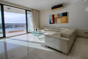 A seating area at The Strand Apartments By Homely