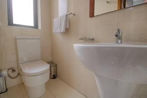 A bathroom at The Strand Apartments By Homely