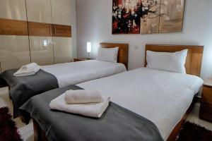 A bed or beds in a room at The Strand Apartments By Homely