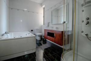 A bathroom at The Strand Apartments By Homely
