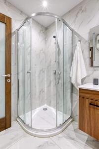 a bathroom with a shower with a glass enclosure at Grand 3BED Burseley Terrace fl2 Swieqi by Homely in Is-Swieqi +32 photos