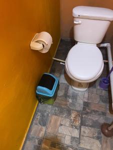 a bathroom with a toilet and a trash can at Casa El Majahual in Playa San Blas