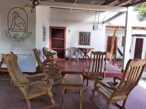 a room filled with rocking chairs and a table at Playa Casa Nohelia in Santo Domingo