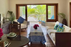 a living room with a couch and a table at Stunning 1 Bedroom Hideaway Palm / Garden View in Gaynors