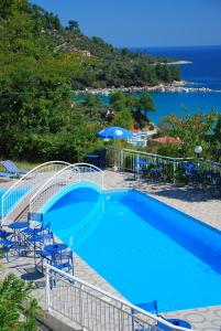 uma piscina com cadeiras e vista para o oceano em Hotel Smaragdi em Chrysi Ammoudia