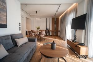 ein Wohnzimmer mit Sofa und Tisch in der Unterkunft Volos Inn Hotel in Volos