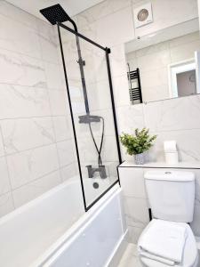 a white bathroom with a shower and a toilet at Fantastic Home! Football Fans -5 min to Stadium in Liverpool