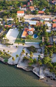an aerial view of a resort with palm trees and water at Rancharia Charme Beach - Pé na Areia in Atins