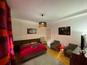 a bedroom with a bed and a living room at Monolit Budapest Center Guesthouse in Budapest