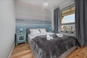 Posteľ alebo postele v izbe v ubytovaní Apartament Morski