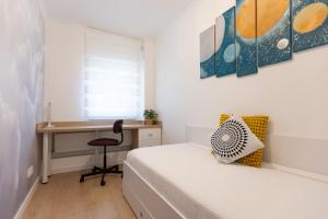 a bedroom with a bed and a desk with a chair at Imedio Olive Apartment Aviatiei in Bucharest