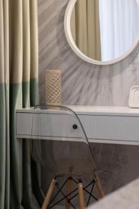 a bathroom counter with a mirror and a sink at Imedio Olive Apartment Aviatiei in Bucharest +28 photos