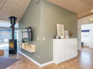a living room with a fireplace and a wall at 4 star holiday home in Ansager-By Traum in Ansager