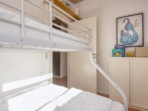 a bedroom with a bunk bed with a ladder at 4 star holiday home in Ansager-By Traum in Ansager