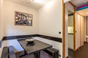 a room with a table with a bowl on it at LAUZES G - Appartement LAUZES 38 pour 5 Personnes 00 in Valmorel