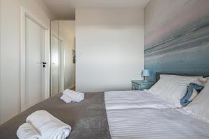 Posteľ alebo postele v izbe v ubytovaní Apartament Morski