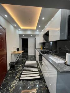 a kitchen with black marble floors and a counter top at Stay in the heart of the city in Istanbul