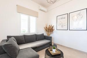 a living room with a couch and a table at Spacious & Luxe 3BR Downtown 1min to Beach in Kos