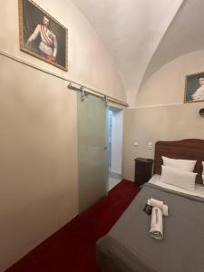 a bedroom with a bed and a glass shower at DATRI Petite Suite 8 in Vienna