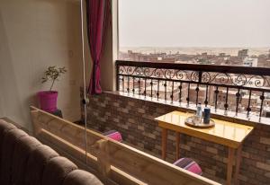 a balcony with a table and a view of a city at Giza Pyramids View Apartment in Cairo