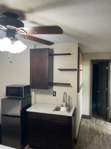 a kitchen with a sink and a ceiling fan at cozy studio apartment with private entrance and patio in Miami