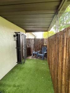 a patio with a fence and a chair and a table at cozy studio apartment with private entrance and patio in Miami