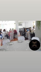 a table and chairs with people in a room at Hotel Restaurante Costas - Fortuna in Fortuna +99 photos