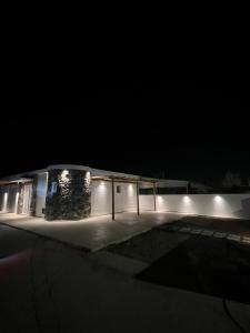 a building lit up at night with lights at JOHANNES LUXURY VILLAS in Kolymbia