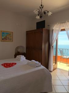 a bedroom with a bed with a view of the ocean at Anna Apartment in Positano