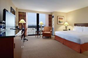 Pokój hotelowy z dużym łóżkiem i telewizorem w obiekcie Hilton Chicago O'Hare Airport w mieście Rosemont