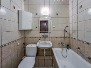a bathroom with a toilet and a sink and a tub at Legnicka Budget Stay - Grysko Apartament's in Szczecin