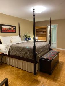 a bedroom with a large bed with a wooden floor at Downtown Halifax suites in Halifax