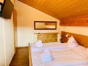 シュヴァンガウにあるFerienwohnung Forggensee-Blickのベッドルーム1室(ベッド2台、タオル付)