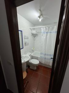 a bathroom with a toilet and a sink at Posada la Torre in Serdió