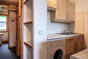 a kitchen with a washing machine and a sink at CHEVAL BLANC G - Appartement CHEVAL BLANC E08 pour 4 Personnes 31 in Valmorel