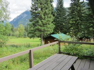 a wooden bench sitting on a wooden fence in a field at Mount Robson Lodge in Mount Robson
